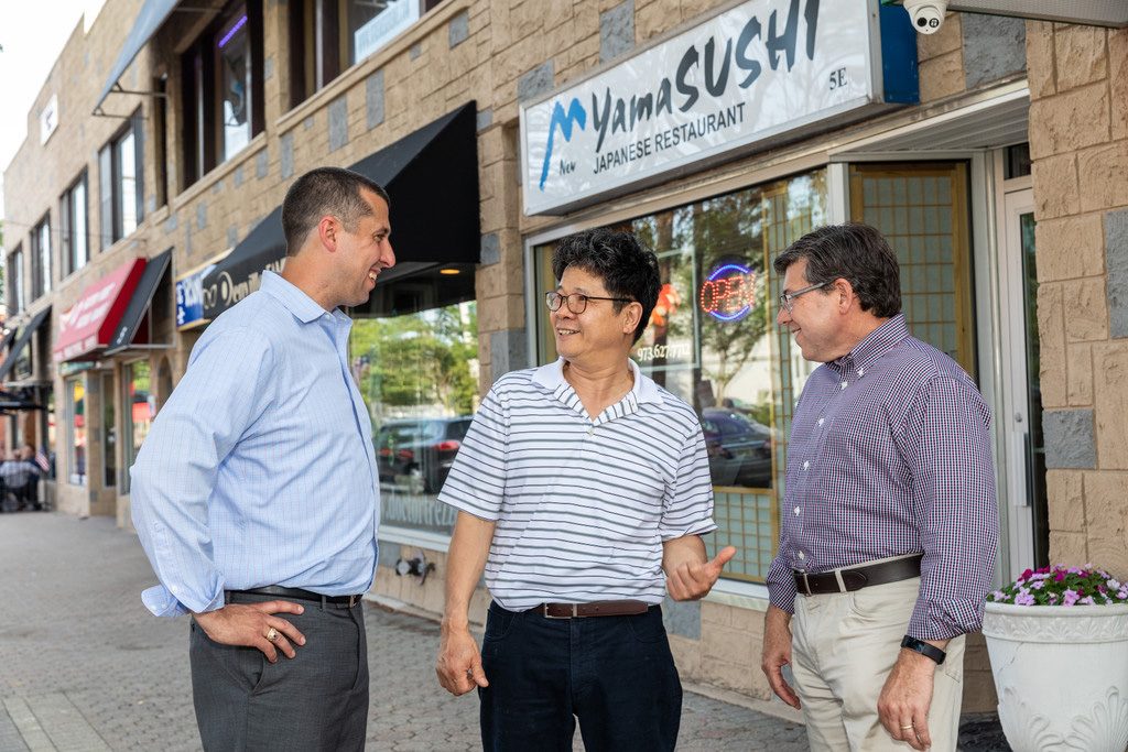 Brian Bergen talking with small business owners on Main Street