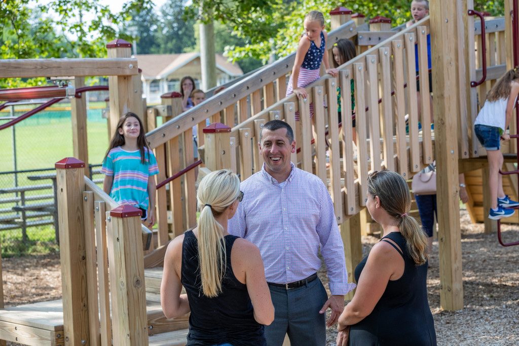 Brian Bergen talking with families at a playground