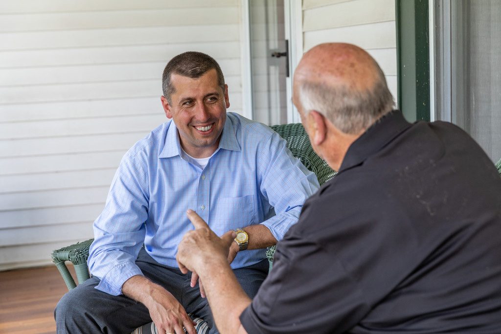 Brian Bergen talking with a constituent on a front porch